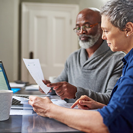 Picture of couple completing forms- consumer assisitance webpage includes useful information to help you make informed decisions about your money and to protect yourself against financial scams and fraud.