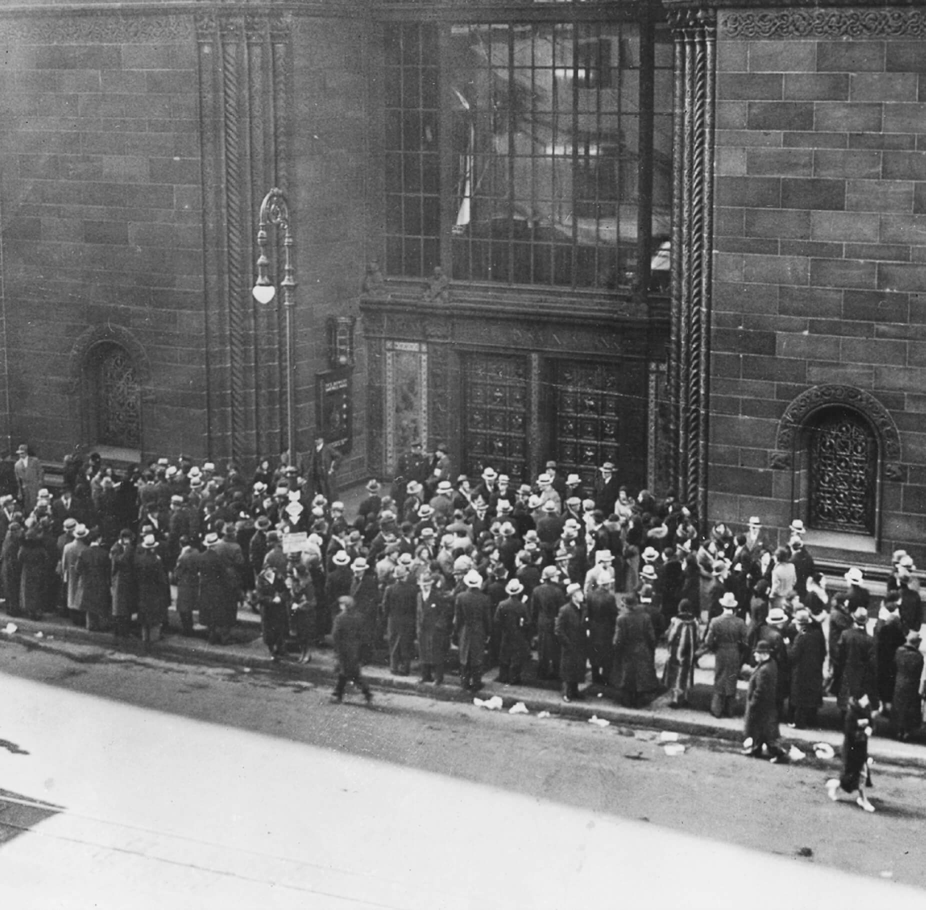 People waiting in line to enter the bank