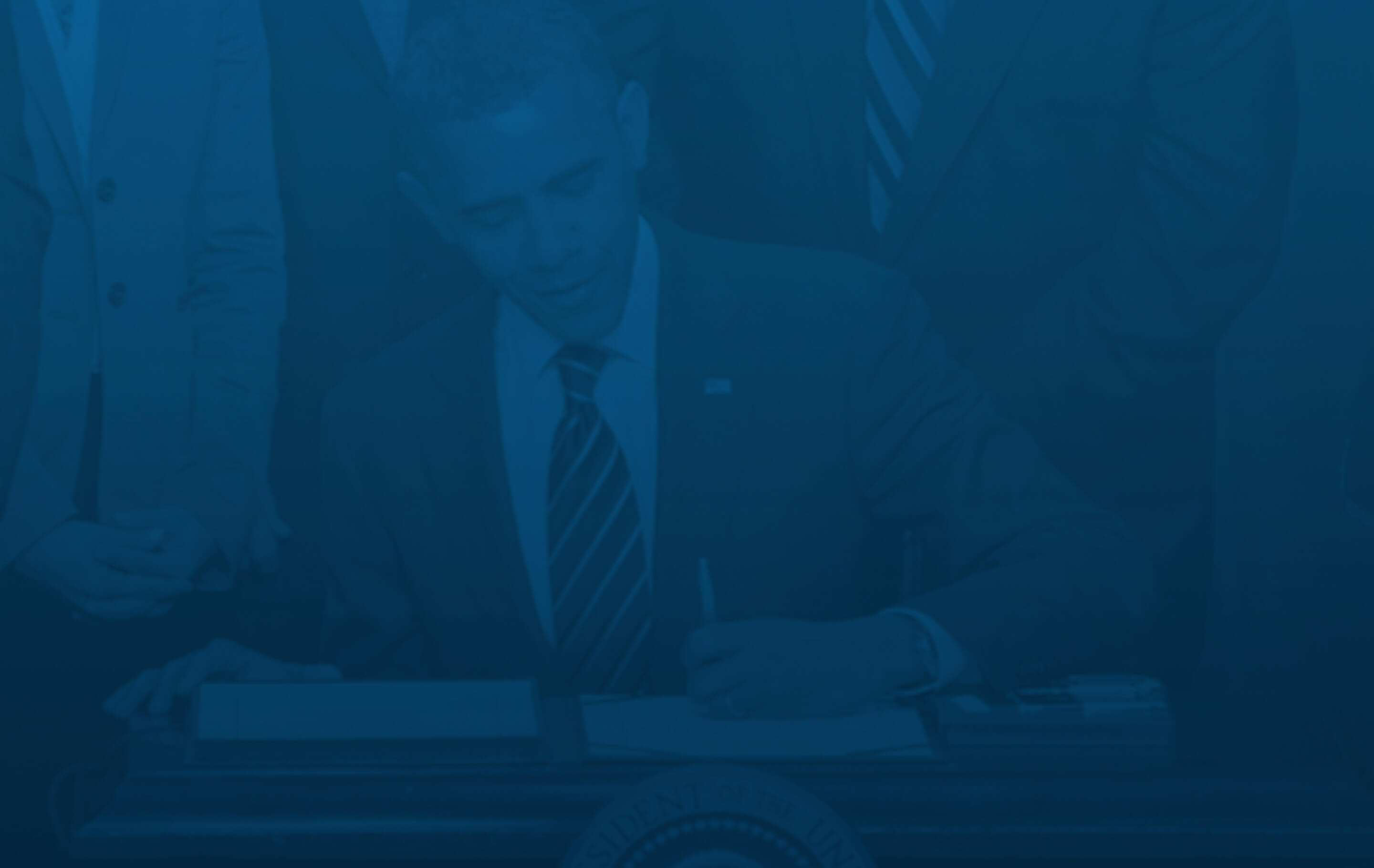 Background image: Barack Obama signing a bill
