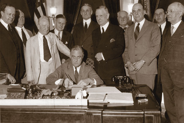 On June 16, 1933, President Roosevelt signed the act that created the FDIC. He was surrounded by congressional leaders, including Senator Carter Glass and Representative Henry Steagall, both of whom lent their names to the law. 