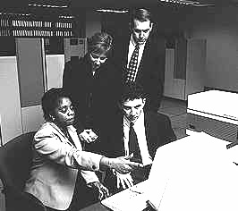 Group of people looking at computer monitor