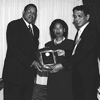 Photograph: Directors Mickey Collins (left) of the FDIC's Office of Diversity and Economic Opportunity and Arleas Upton Kea (center) of the Division of Administration accept an award on behalf of the FDIC from the Federal Asian Pacific American Council for the agency's excellence in diverstiy programs.