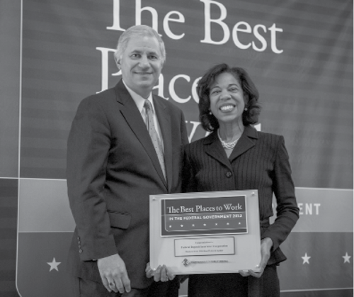 Photograph of Chairman Martin J. Gruenberg and Arleas Upton Kea, Director of the Division of Administration, accepting the award for the number one ranking among mid-sized federal agencies for Best Places to Work in the Federal Government