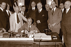 Photo of President Roosevelt signing the Banking Act of 1933