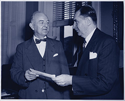 Photo of FDIC Chairman Maple Harl (right) presenting check for $146 million to Undersecretary of the Treasury Wiggins in 1947.