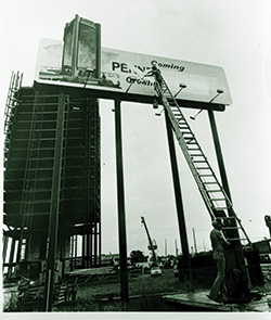 Image of Unfinished Penn Square Bank Building and Sign Announcing the Building Being Erased